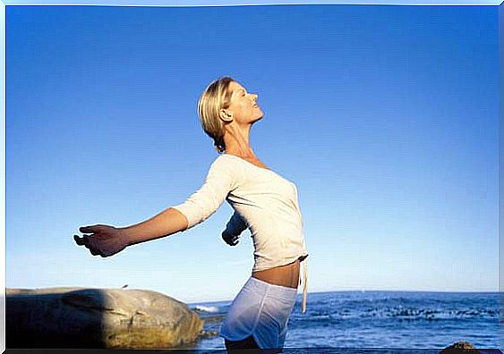 Woman who is by the water and breathing deeply