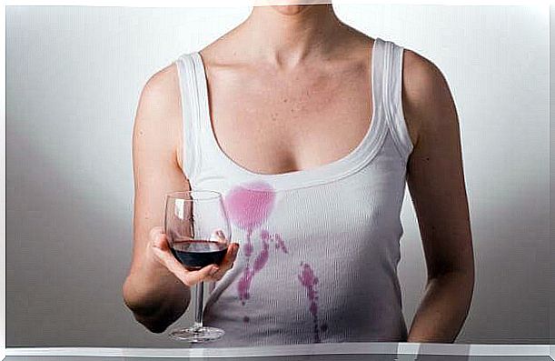 Woman with red wine stains on her tank top