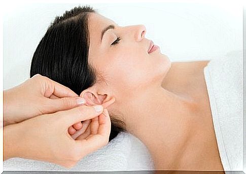 Woman getting her ears massaged