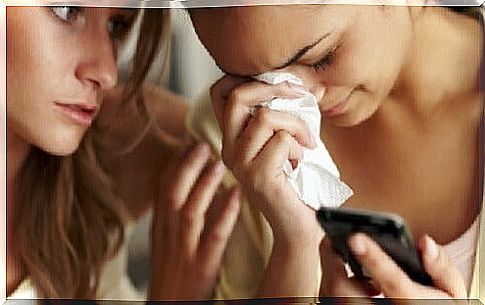 Woman crying while friend comforts her