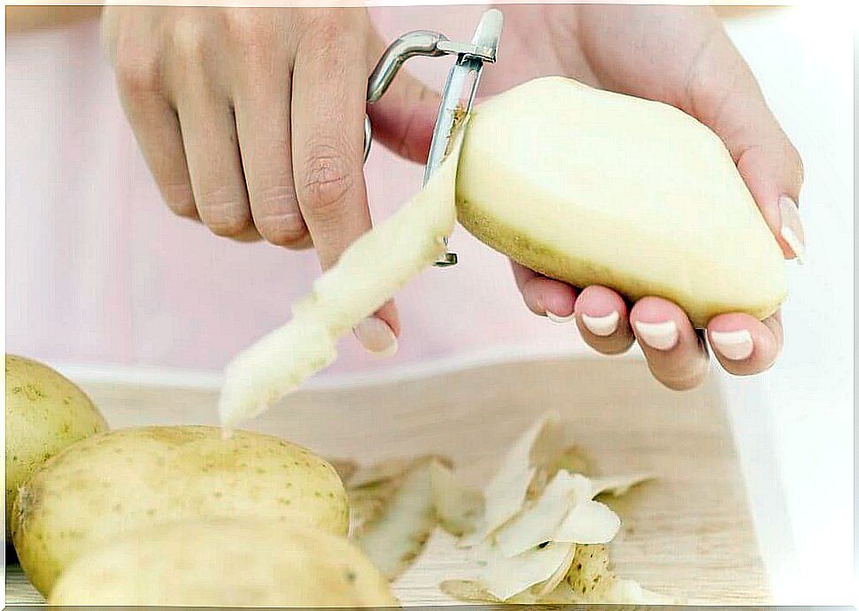 Person peeling potatoes