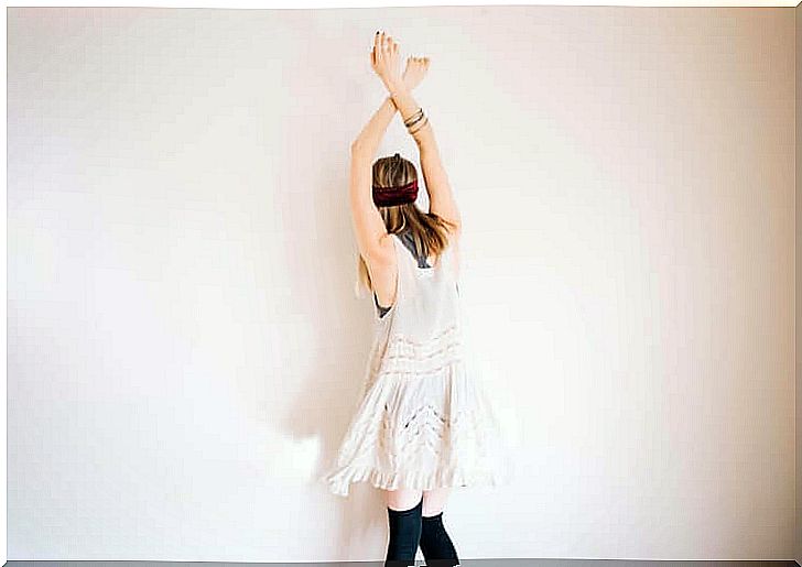 Woman standing with her hands over her head