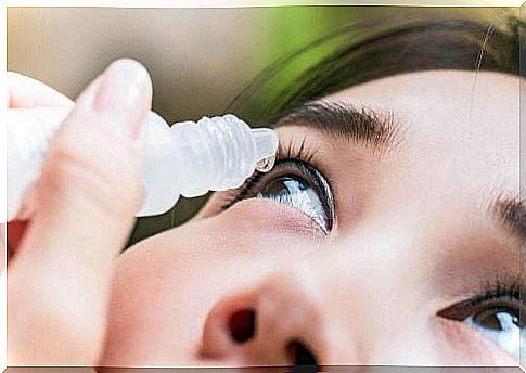 Woman taking eye drops - natural to fight red eyes