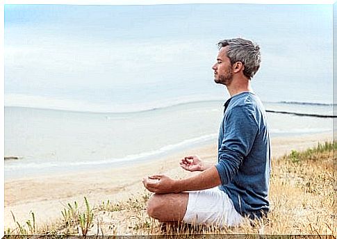 Man meditating by the water