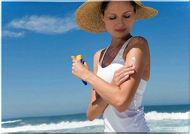 Woman applying sunscreen