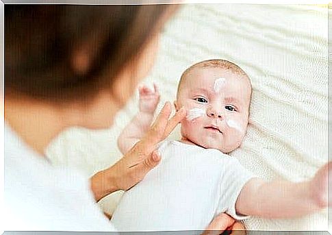 A baby gets cream on