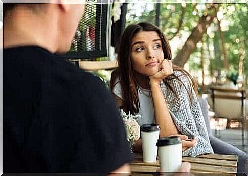 Woman looking away while man talking to her