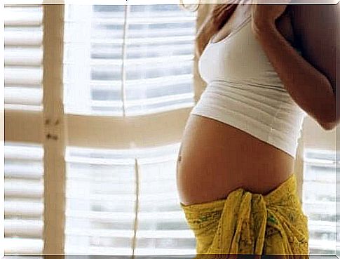 Pregnant woman in front of window