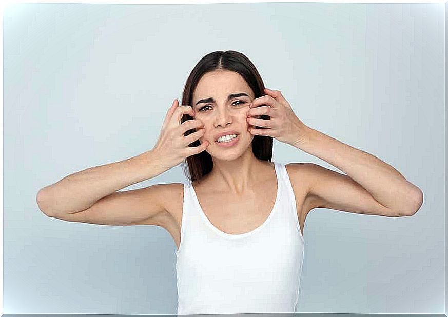 Woman scratching her face