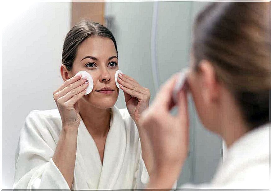 A woman cleaning her face