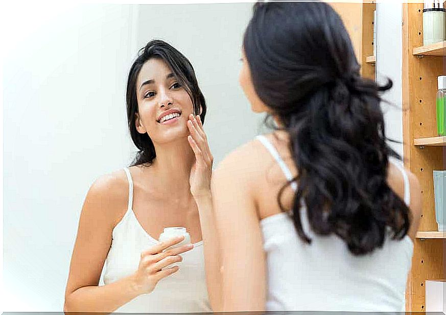 A woman gets face cream on