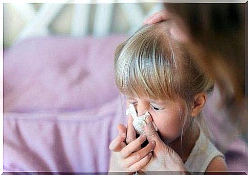 A girl brushes her nose