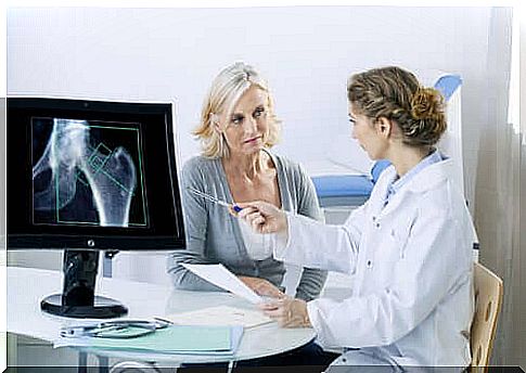 Woman gets x-ray checked by doctor to prevent bone loss