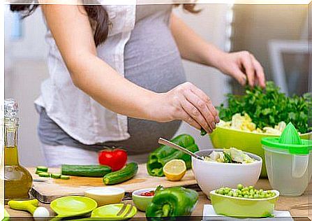 Pregnant woman making salad