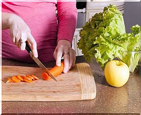 Pregnant woman making salad