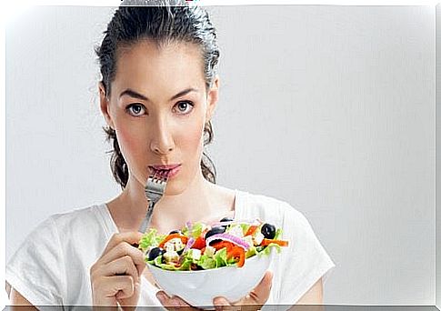 Woman eating salad