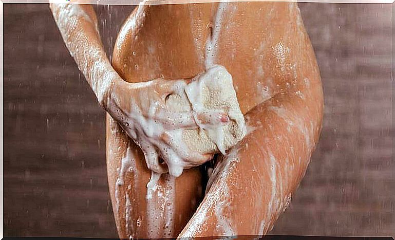 Woman washing herself with a sponge