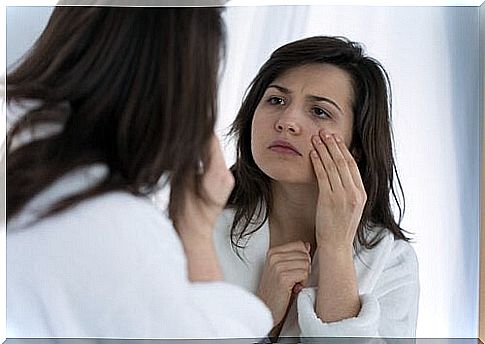 woman looking at skin under the eye