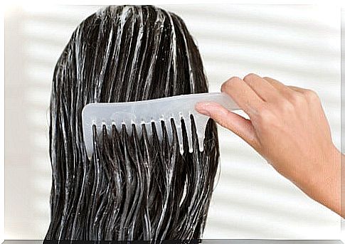 Woman leads comb through her hair