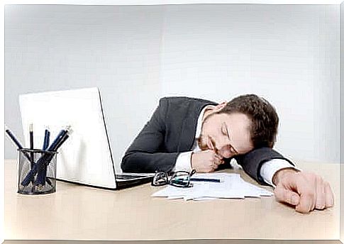 Man sleeping on desk as example of the different types of insomnia