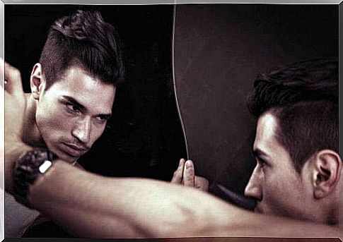 Man suffering from narcissistic personality disorder looks in mirror