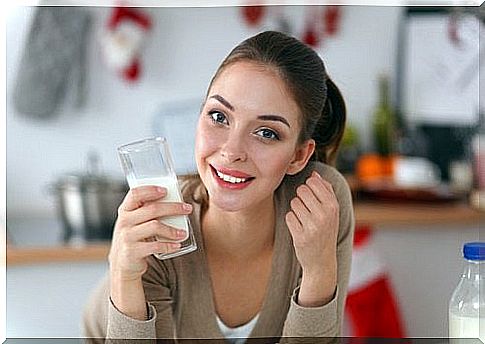 Woman smiling with a glass of milk