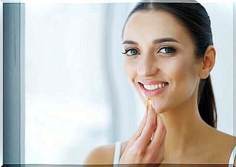 Smiling woman taking supplements