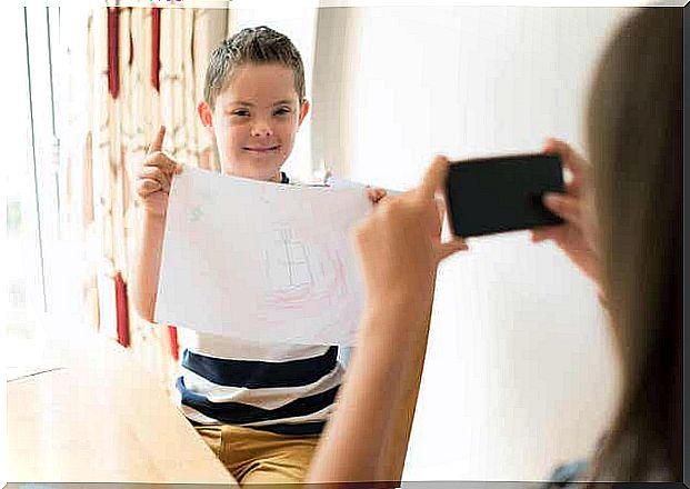 Child with paper has one of the common types of disability