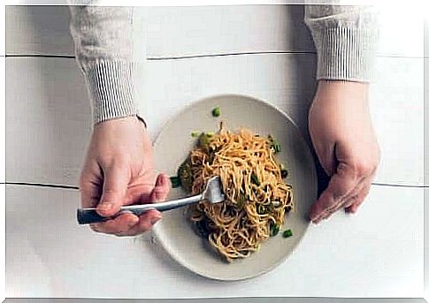 Person eats a portion of pasta