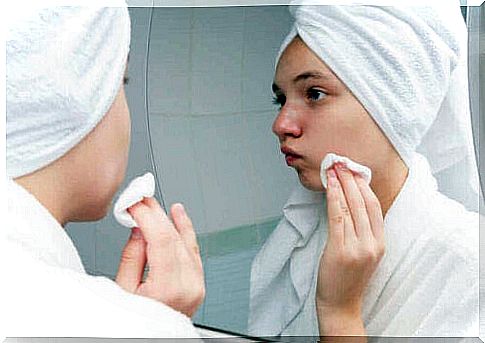 Woman applying acne treatments