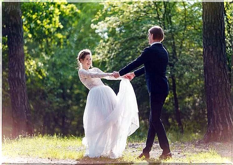 Bride and groom dancing outside