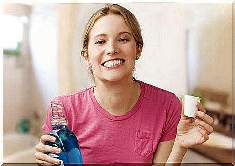 Woman going to drink mouthwash.