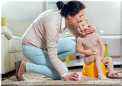 Child on potty with mother next door