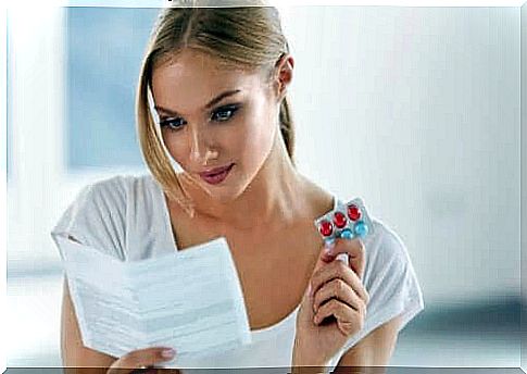 A woman reading the information about a drug