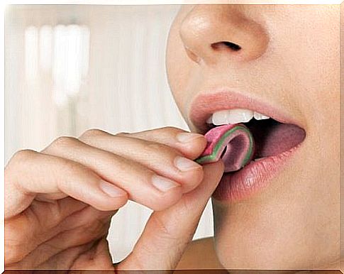 Woman getting flat chewing gum in mouth