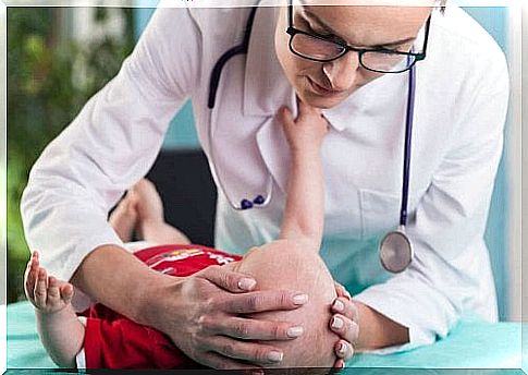 Baby hit his head and is being checked by a doctor