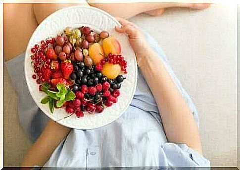 Woman with fruit platter as it is something one should eat during a pregnancy