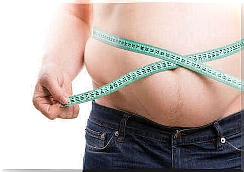 Obese person measures his stomach